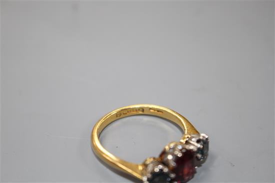 A 1930s 22ct gold, garnet and sapphire? three stone dress ring,